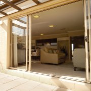 View through glass sliding doors into lounge area ceiling, door, floor, interior design, window, brown, yellow