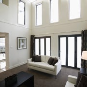 Lounge room with large void to ceiling, large architecture, ceiling, daylighting, floor, flooring, home, interior design, living room, room, window, gray, white, black