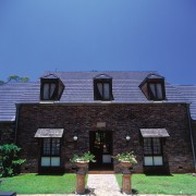 Exterior of house with aged brick cladding, steep architecture, building, cottage, elevation, facade, home, house, property, real estate, residential area, roof, siding, sky, suburb, window, blue, black