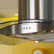 Close-up of stainless steel canopy hood with curved product, product design, orange, brown