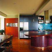 Kitchen with curved timber island, dark coloured cabinetry, architecture, cabinetry, ceiling, countertop, floor, flooring, hardwood, home, house, interior design, kitchen, real estate, room, table, wood, wood flooring, red, brown