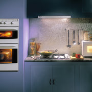 Kitchen featuring light blue cabinetry, wall ovens, cooktop, hearth, home appliance, kitchen, kitchen appliance, kitchen stove, major appliance, oven, wood burning stove, black, gray