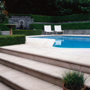 View of the concrete steps leading up to backyard, landscaping, outdoor furniture, outdoor structure, sunlounger, swimming pool, walkway, water feature, wood, yard, black, white