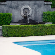 Close up view of the water feature, hedges, garden, grass, green, landscaping, plant, reflecting pool, reflection, swimming pool, wall, water, water feature, water resources