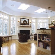 View of a living area, wooden flooring, large cabinetry, ceiling, floor, flooring, furniture, hardwood, home, interior design, kitchen, living room, room, shelving, wall, window, wood, wood flooring, white