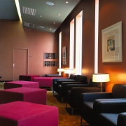 Foyer of cinema complex with painted walls and auditorium, café, ceiling, furniture, interior design, lighting, lobby, room, table, black, brown