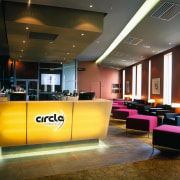 Bar area in cinema complex with yellow cabinetry, ceiling, interior design, lighting, lobby, brown