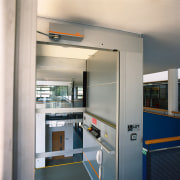 Interior of platform lift with glass panels and gray