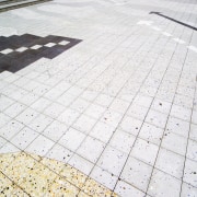 Patterned tiles in paved courtyard. - Patterned tiles cobblestone, daylighting, floor, line, material, pattern, road surface, roof, walkway, white