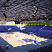 Interior of basketball stadium with blue seating, showing arena, basketball court, sport venue, sports, stadium, structure, blue