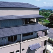 view of the overhanging eaves showing the csr architecture, building, condominium, daylighting, elevation, facade, home, house, property, real estate, residential area, roof, siding, window, blue