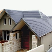 Exterior view of front of house with tan daylighting, facade, home, house, property, real estate, roof, siding, gray