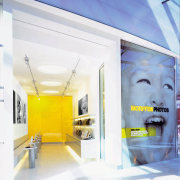 View of a showroom, many photos, many laptops ceiling, interior design, product design, wall, yellow, white