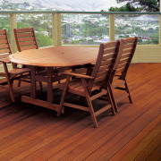 Outdoor patio area with timber decking, round timber chair, deck, floor, flooring, furniture, hardwood, laminate flooring, outdoor furniture, outdoor structure, patio, table, wood, wood flooring, wood stain, red