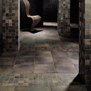 Area with coloured tiles and mosaic tiles, columns brick, concrete, floor, flooring, light, tile, wall, wood, black, gray