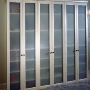 view of the vertical frosted glass panels for cabinetry, door, window, gray