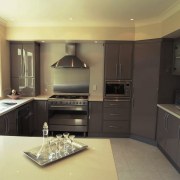 Kitchen with brown grey cabinetry, cream benchtop, stainless cabinetry, countertop, cuisine classique, interior design, kitchen, real estate, room, black