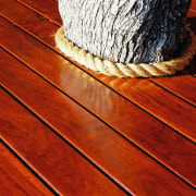 A view of some wooden decking. - A floor, flooring, hardwood, line, rope, wood, wood flooring, wood stain, yellow, red