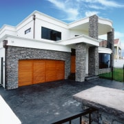 Exterior of home with schist stone cladding, on architecture, building, elevation, estate, facade, home, house, property, real estate, residential area, white