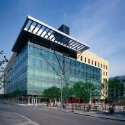 View of a large concrete, steel and glass architecture, building, city, commercial building, condominium, corporate headquarters, daytime, downtown, facade, headquarters, metropolis, metropolitan area, mixed use, real estate, residential area, sky, tower block, teal