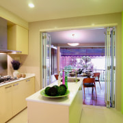 view of the kitchen with muted cabinetry offset apartment, countertop, home, interior design, kitchen, real estate, room, orange, yellow