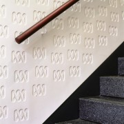 Stairway with ornate plaster panel on wall. - font, product design, wall, white