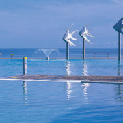 A view of the esplanade lagoon area, 4 calm, coastal and oceanic landforms, energy, ocean, sea, shore, sky, vacation, water, wave, wind, wind farm, wind turbine, teal