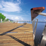A close up view of the wooden and boardwalk, cloud, fixed link, horizon, sea, sky, walkway, water, teal