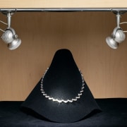View of a necklace in a wooden cabinet lighting, product design, table, brown