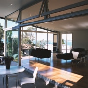 Lounge area with large openings to outdoor area. architecture, daylighting, house, interior design, living room, real estate, roof, window, black