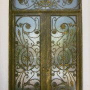 Close up view of a wooden door with door, glass, iron, metal, brown, gray