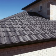 Closeup of grey concrete roof tiles. - Closeup daylighting, facade, outdoor structure, roof, siding, sky, wall, window, black