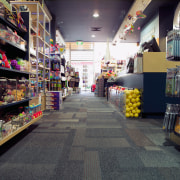 View of retail shop with carpet floor tiles, aisle, convenience store, grocery store, retail, shopping, supermarket, gray, black