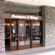 Exterior view of Shampoo 'n' Things shop featuring door, retail, window, gray, white