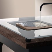 A close up view of a table like bathroom sink, furniture, plumbing fixture, product, product design, sink, table, tap, gray, black