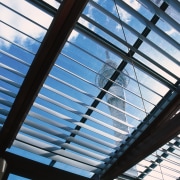 View of aluminium window louvres with Sky Tower angle, architecture, building, daylighting, daytime, facade, glass, light, line, metal, metropolitan area, roof, sky, steel, structure, symmetry, window, teal, black