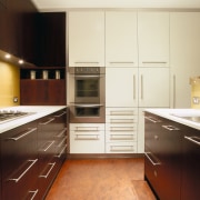 view of the kitchen showing dark stained american cabinetry, countertop, cuisine classique, floor, flooring, hardwood, interior design, kitchen, room, under cabinet lighting, wood flooring, yellow