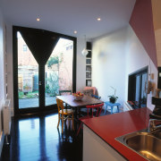 view of the kitchen and dining area showing architecture, ceiling, countertop, daylighting, flooring, home, house, interior design, kitchen, living room, loft, property, real estate, room, table, window, gray