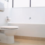 view of this clean white bathroom showing toilet bathroom, bathroom accessory, bathroom cabinet, bathroom sink, bidet, ceramic, floor, interior design, plumbing fixture, product, product design, property, room, sink, tap, tile, toilet, toilet seat, wall, white, gray