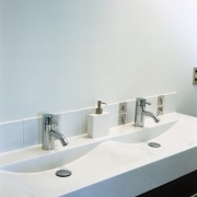 view of the contemporary baathroom featuring villaboard bathroom, bathroom sink, plumbing fixture, product design, sink, tap, white, gray