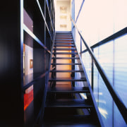 A view of a wooden staircse, wooden railing architecture, building, daylighting, glass, handrail, line, stairs, structure, black, white