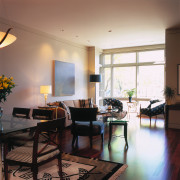 A view of a living area, wooden flooring, apartment, ceiling, dining room, furniture, home, house, interior design, living room, real estate, room, table, window, white