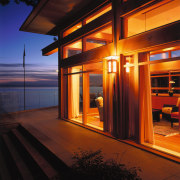 view of the doors that open from the architecture, evening, home, house, light, lighting, reflection, sky, window, wood, red