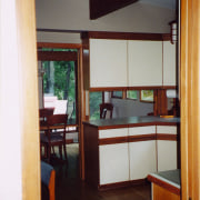 A view of the kitchen and dining areas cabinetry, door, furniture, house, interior design, room, shelving, table, window, red