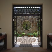 view of the outdoor shower featuring rain head glass, interior design, window, black, brown