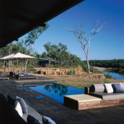 view of the outdoor entertainment area where guest architecture, house, leisure, reflection, resort, sky, swimming pool, tree, water, black