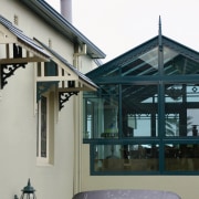 A view of a conservatory from the outside, facade, roof, window, gray, black