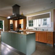 view of the kitchen feautring stainless rangehodd and cabinetry, countertop, cuisine classique, flooring, interior design, kitchen, real estate, room, gray