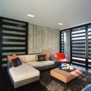 view of the entertainment lounge featuring sliding shutters ceiling, interior design, living room, real estate, room, window, window covering, gray, black