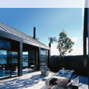 view of the outdoor entertainment area featuring recycled architecture, home, house, property, real estate, residential area, roof, sky, white